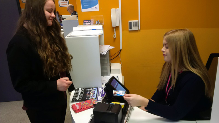 Young job seeker from Renfrew getting their smart travel product on their Young Scot saltirecard from staff at the Employability Hub