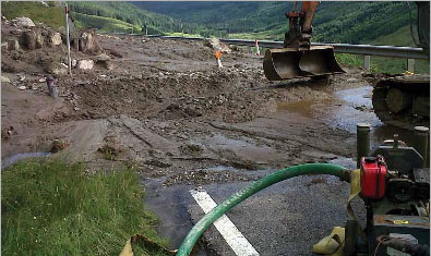 Clearing up a landslide on the A83 (Courtesy of Scotland Transerv)