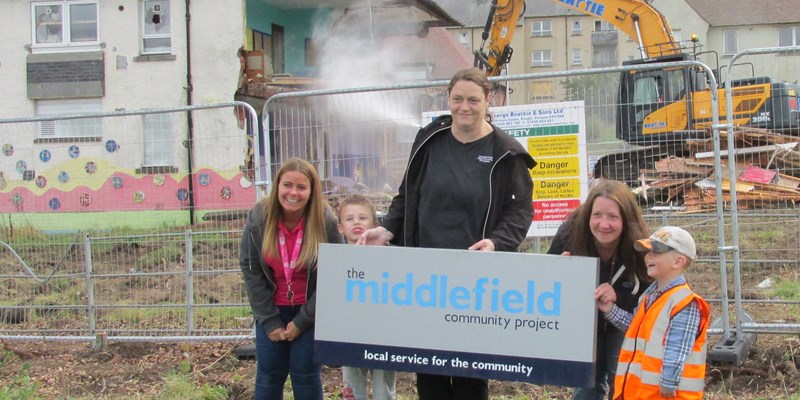 With the sign at the demolition