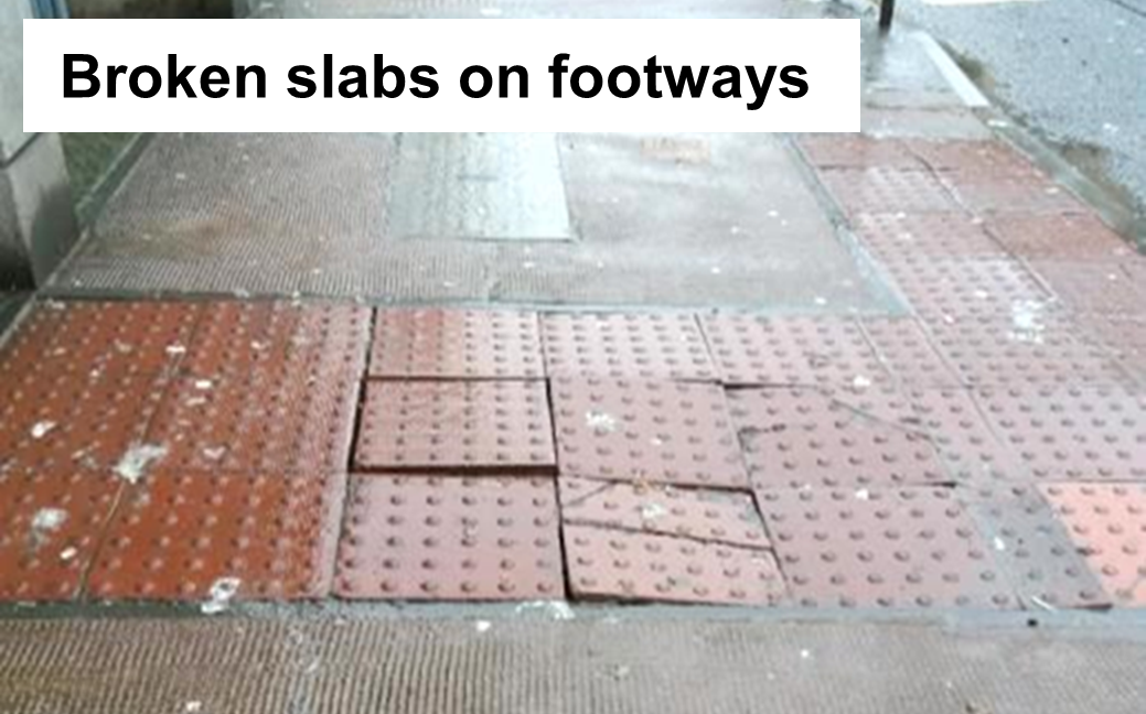 Cracked slabs of tactile paving on a pavement