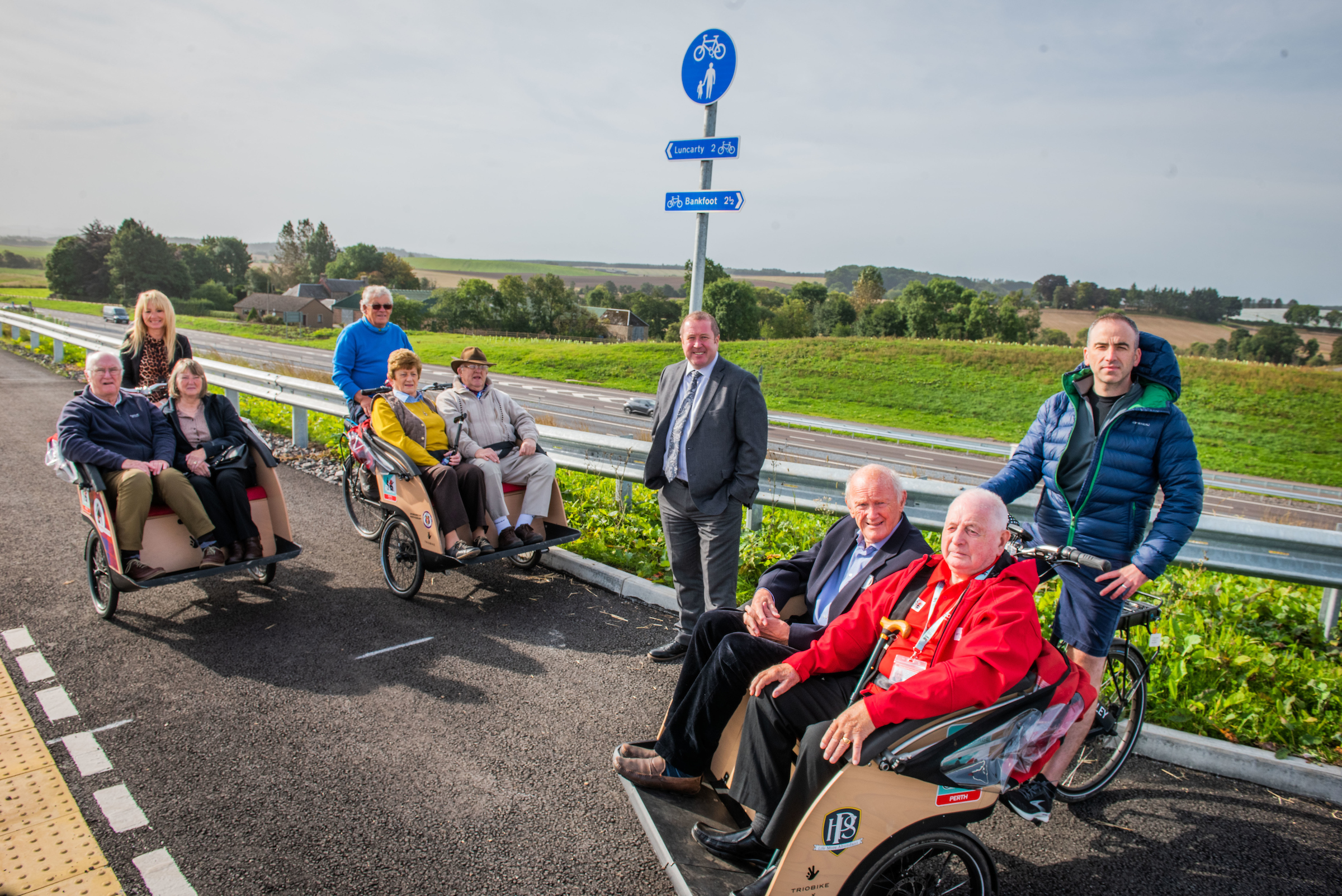 Transport Minister Graeme Dey joined by members of local community organisation, Stanley Development Trust and charity, Cycling Without Age Scotland, as members of the Trust explored some of the cycle paths