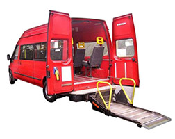 An accessible minibus with a ramp and hand rails.