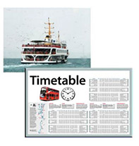 A ferry on the water. A bus timetable.