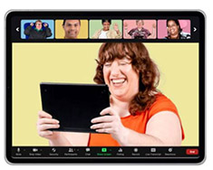 A screen showing a woman holding her tablet and smiling as she sees a row of boxes at the top with different people in them.