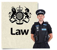 A police officer next to a law document.