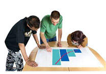 3 people looking at a graph on a table.