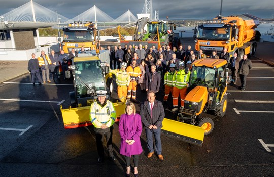 Transport Minister Jenny Gilruth MSP, with a group of people standing in front of vehicles from our Winter Fleet