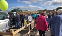 Visitors embarking on a guided tour of the site by minibus