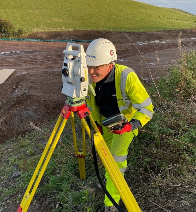 Apprentice, Elliot Moir, on site using surveying equipment