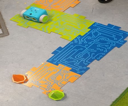 A photograph of logical maths game, Botley the Robot, on the floor
