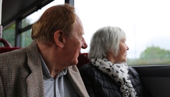 Two people who are aged 60 and over, enjoying access to free bus travel.