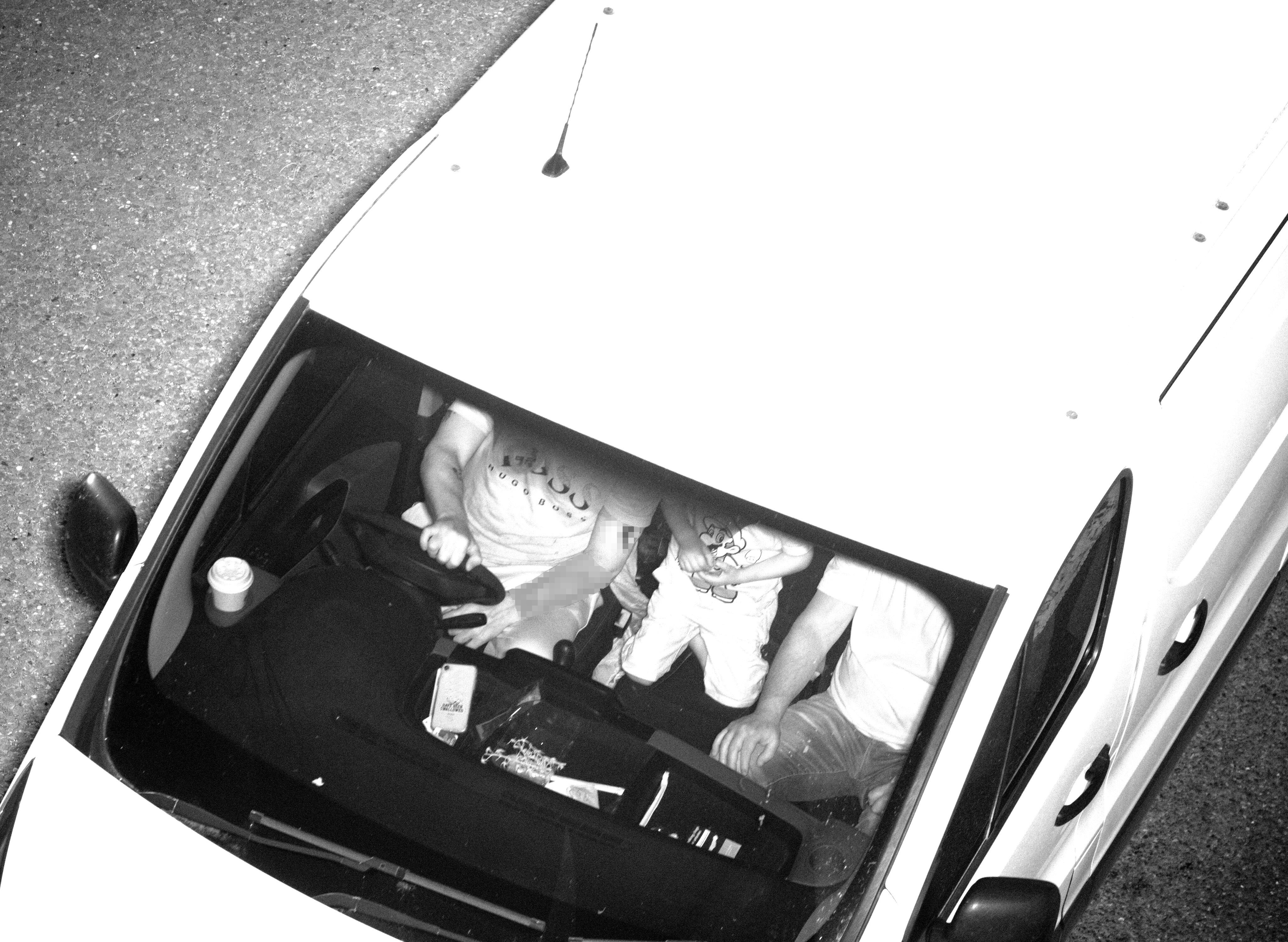 A driver and their two passengers are not wearing seat belts