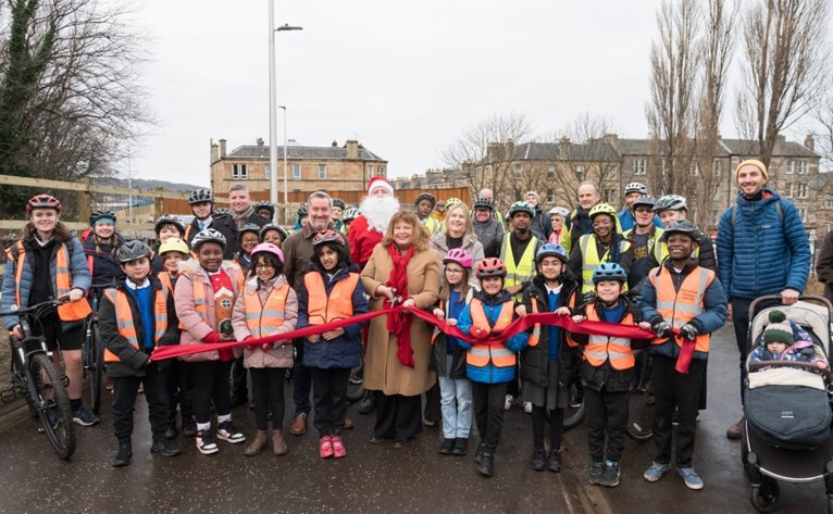 Figure 10: Cabinet Secretary for Transport, Fiona Hyslop, school children, members  of the community celebrating the opening of the Roseburn to Union Canal, as described in the preceding text