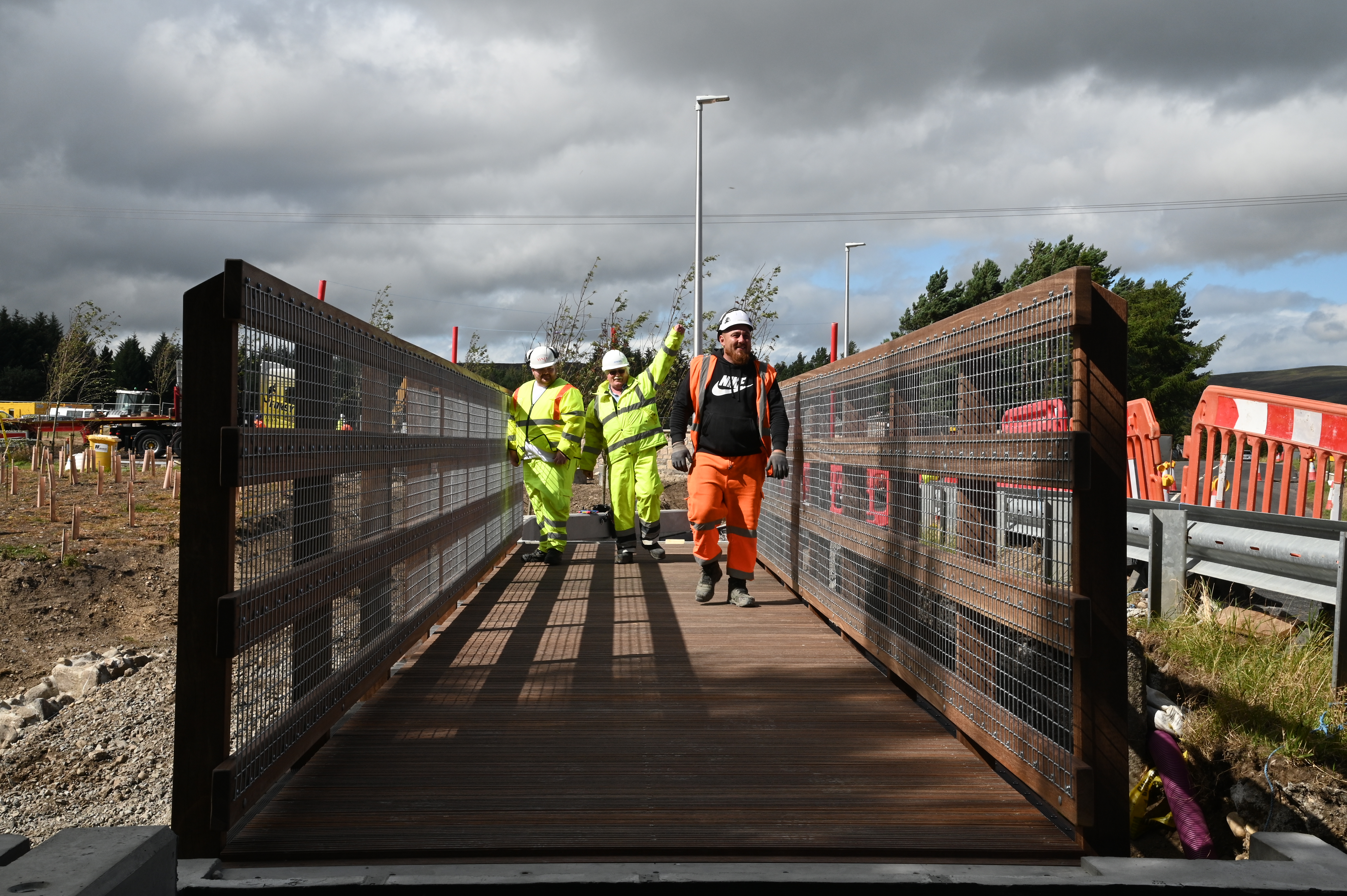 Construction workers installing a footbridge