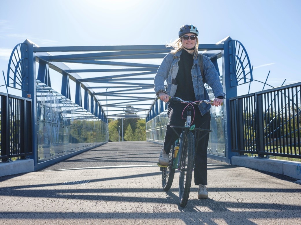 A cyclist on a new pedestrian/cycle bridge.